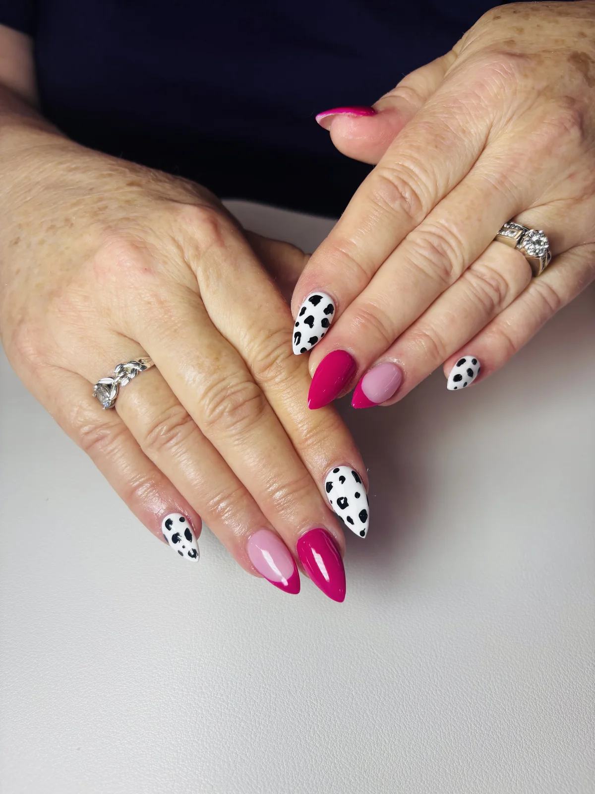 Pink French manicure with playful polka dot accents by Top Ten Nails Spa