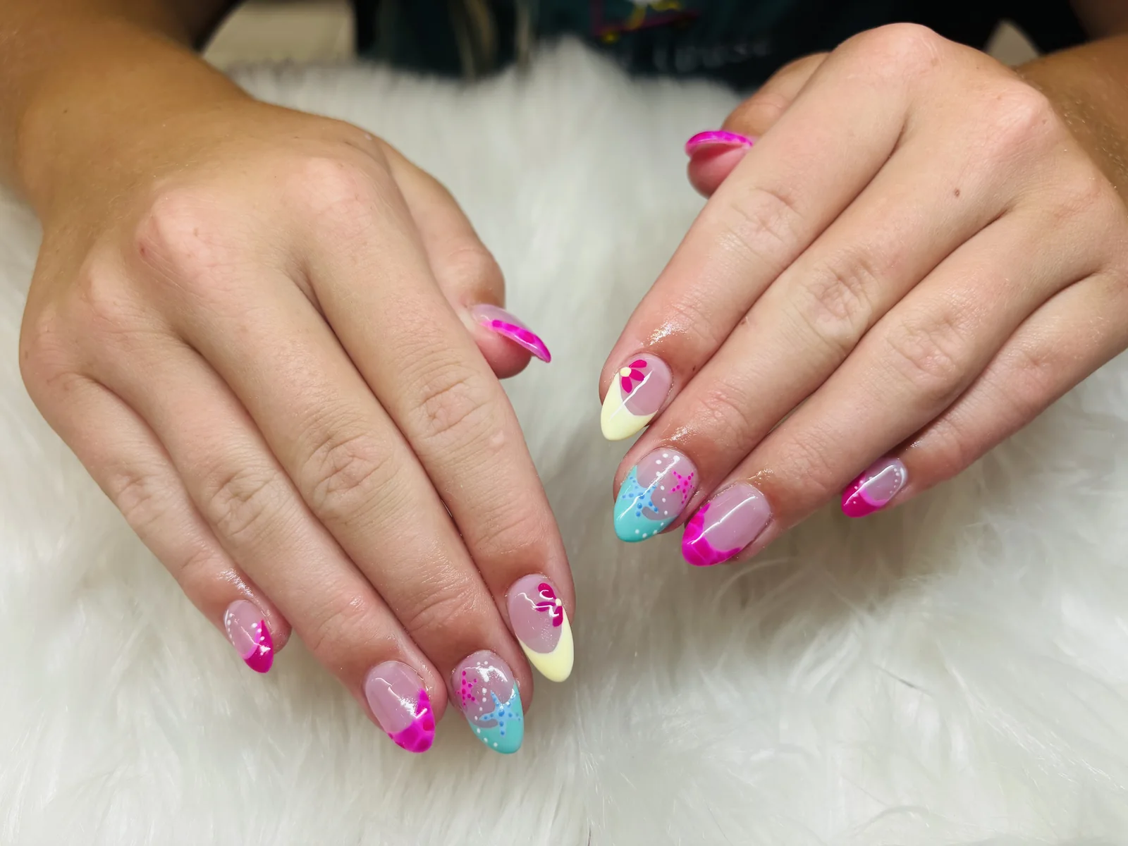 Pink manicure with pastel confetti accents by Top Ten Nails Spa
